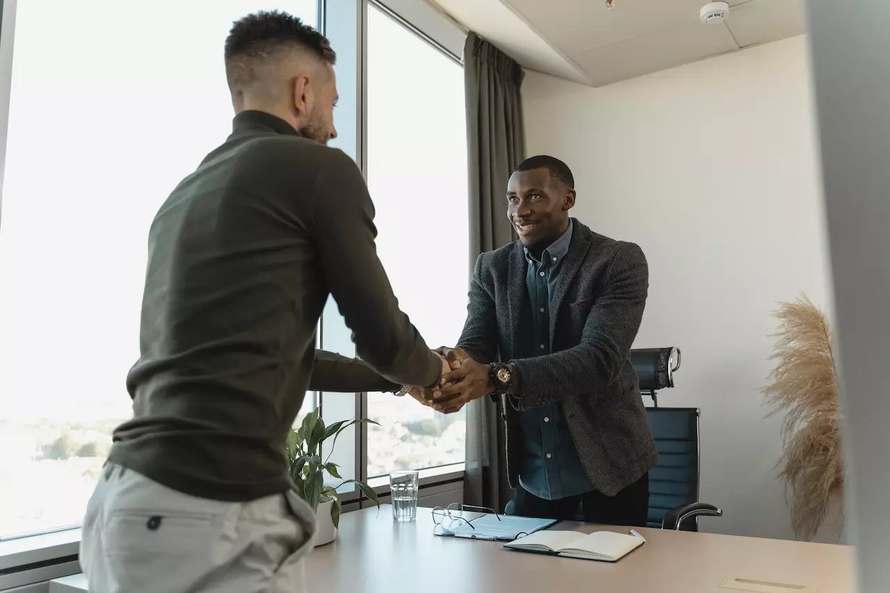 Two professionals shaking hands after a successful hire